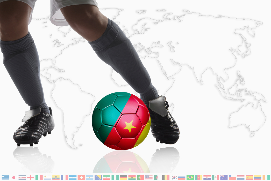 Soccer player dribble a soccer ball with cameroon flag